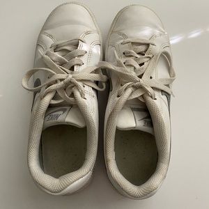White Nike shoes with a silver swoosh